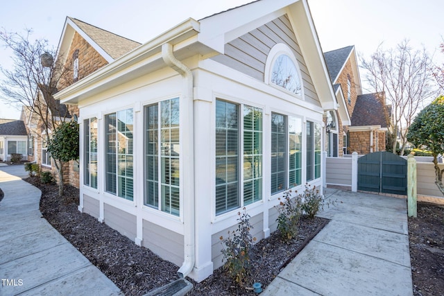 view of side of property featuring a sunroom