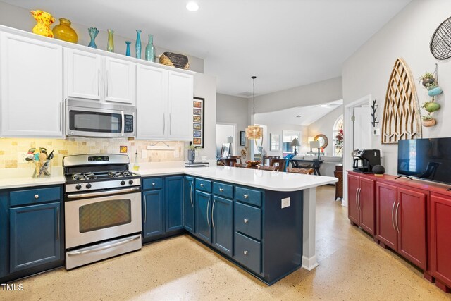 kitchen with kitchen peninsula, appliances with stainless steel finishes, decorative backsplash, white cabinetry, and hanging light fixtures