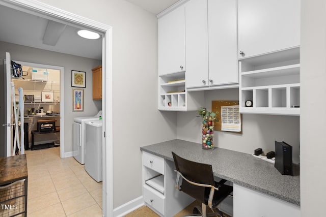 office space with independent washer and dryer, built in desk, and light tile patterned flooring