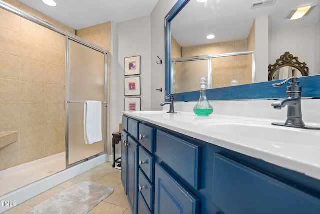 bathroom featuring tile patterned floors, vanity, and a shower with shower door