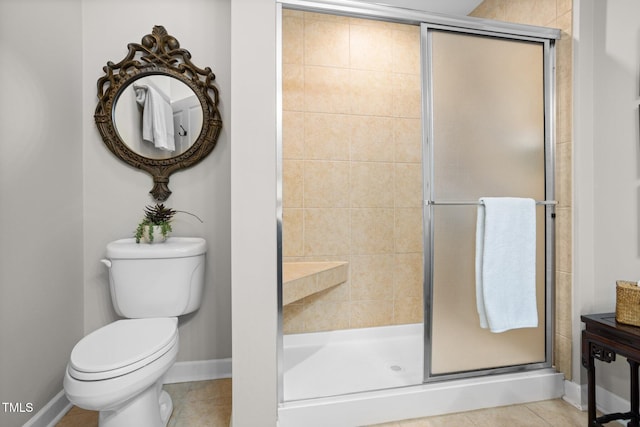 bathroom featuring tile patterned floors, toilet, and walk in shower