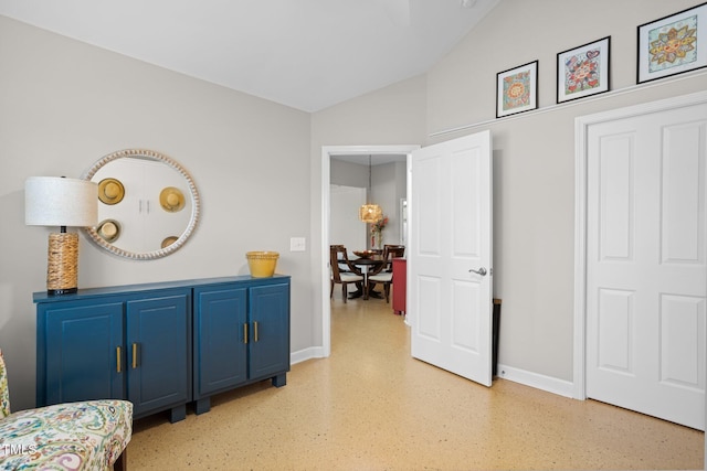 hallway with lofted ceiling