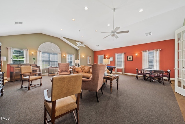 living room featuring dark colored carpet, ceiling fan, and vaulted ceiling