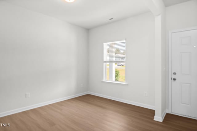 unfurnished room featuring hardwood / wood-style flooring