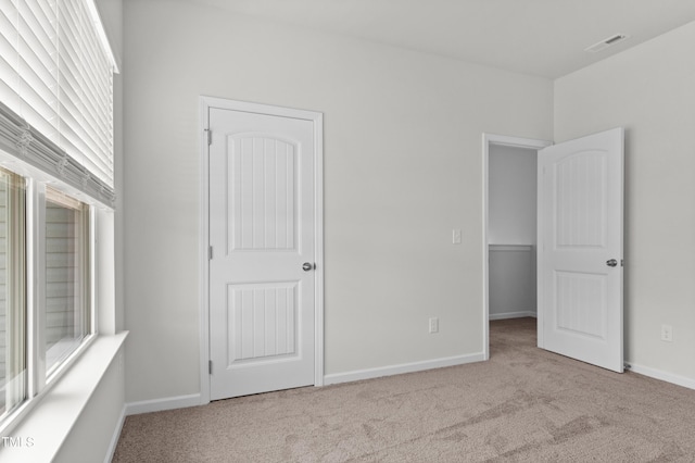 unfurnished bedroom with light carpet