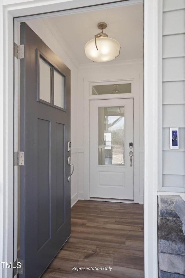 interior space with dark hardwood / wood-style flooring and ornamental molding