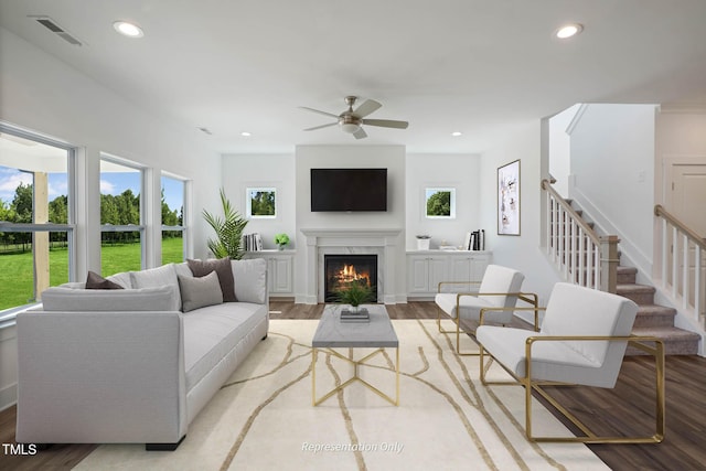 living room with ceiling fan and light hardwood / wood-style floors