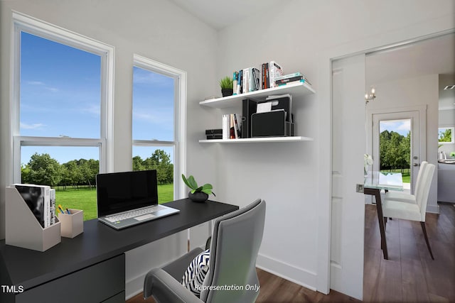 office with dark hardwood / wood-style flooring and a notable chandelier