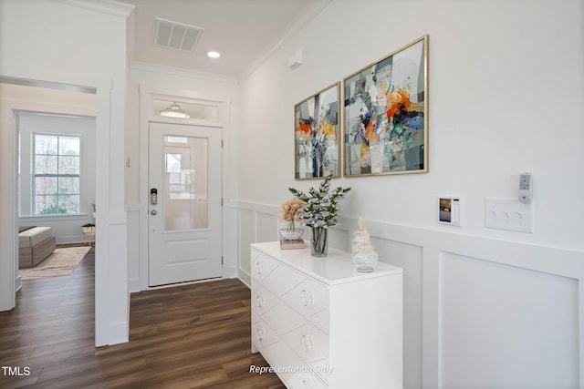 entrance foyer with dark wood-type flooring and ornamental molding