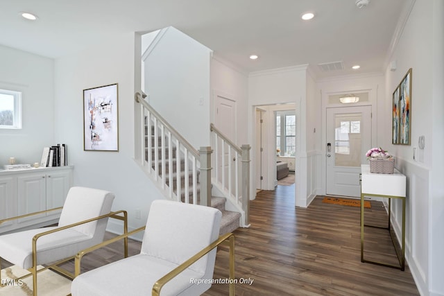 entrance foyer with dark hardwood / wood-style floors and ornamental molding