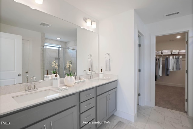 bathroom featuring vanity and a shower with shower door