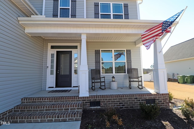 entrance to property featuring a porch