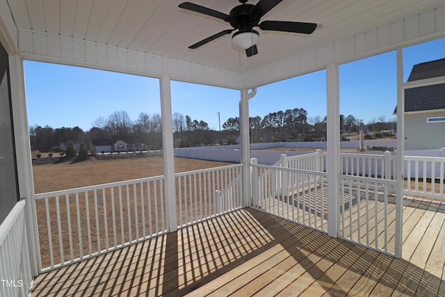 sunroom / solarium with a wealth of natural light and ceiling fan