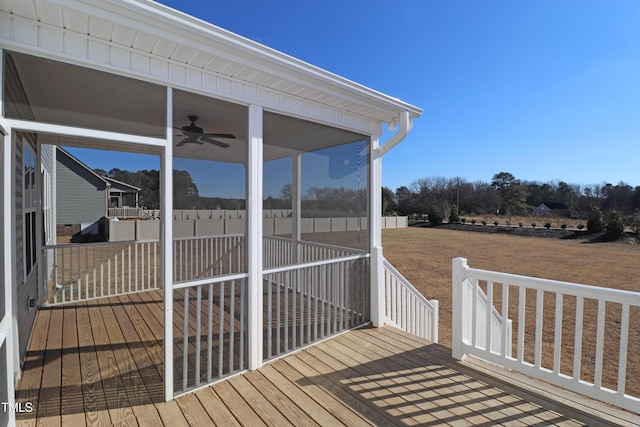 wooden deck with a sunroom and ceiling fan