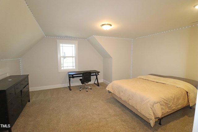 bedroom with carpet flooring and lofted ceiling