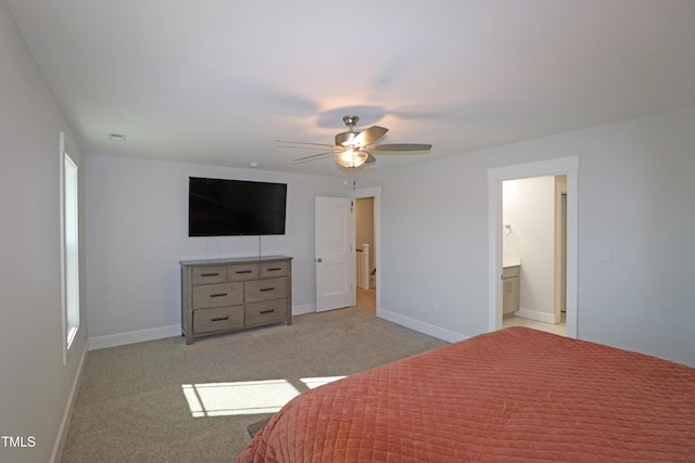 carpeted bedroom featuring ensuite bathroom and ceiling fan