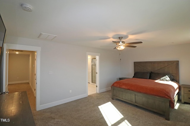 carpeted bedroom featuring connected bathroom and ceiling fan