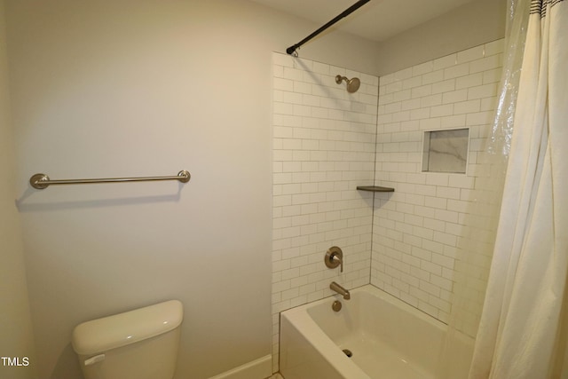 bathroom with toilet and shower / tub combo