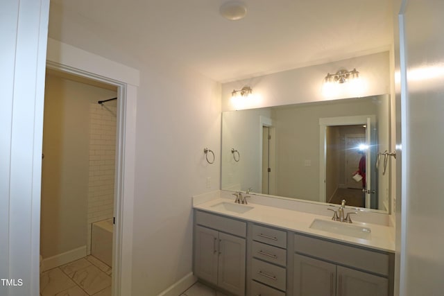 bathroom with vanity and tiled shower / bath