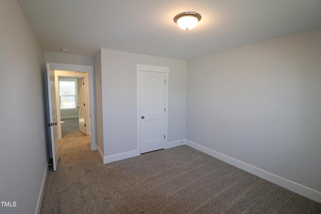 unfurnished bedroom with carpet floors and a closet