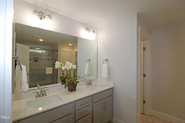 bathroom featuring a shower with door and vanity