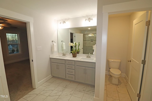 bathroom with vanity, toilet, and a shower with shower door