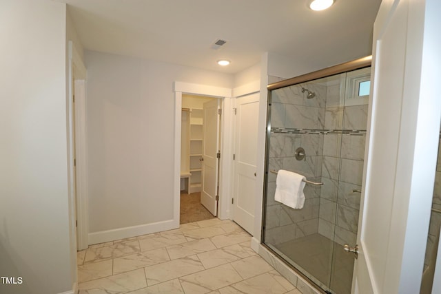 bathroom with a shower with shower door