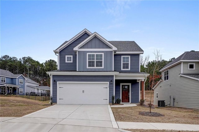 view of front of house with a garage and central AC