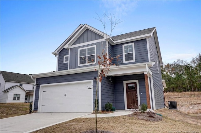 view of front of home with central AC and a garage