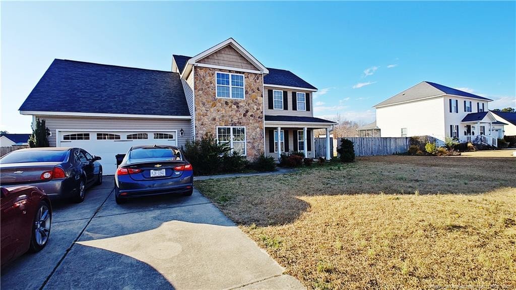 view of front of property featuring a front yard and a garage