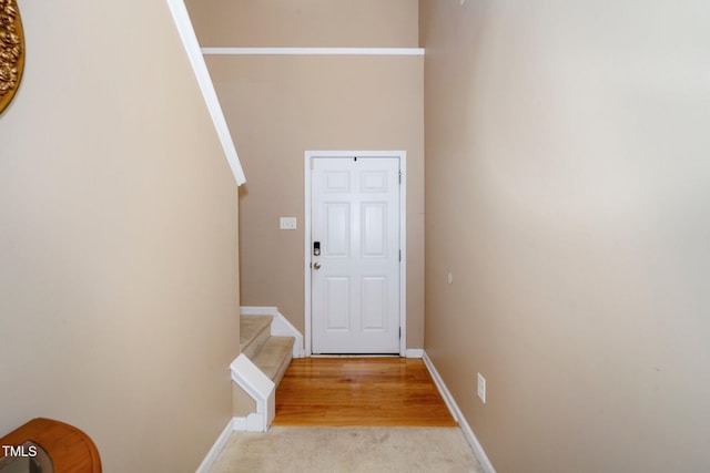 doorway featuring light colored carpet