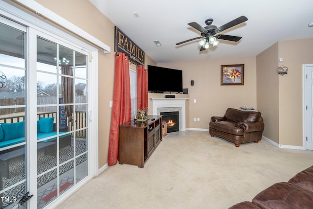 carpeted living room featuring ceiling fan