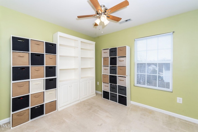 unfurnished bedroom with light colored carpet and ceiling fan