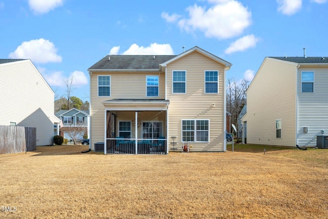 back of house featuring a yard and central air condition unit