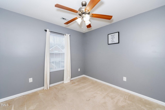 carpeted spare room with ceiling fan