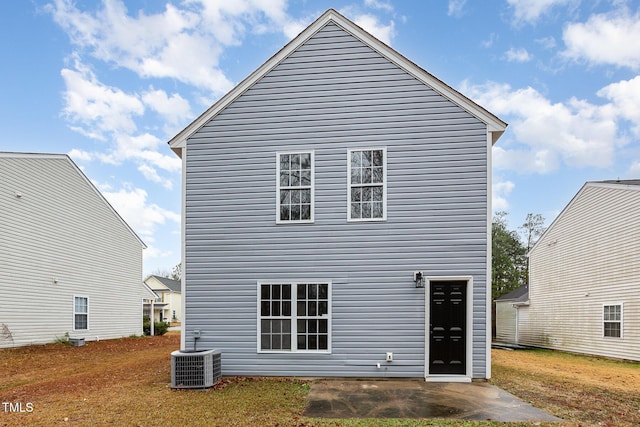 rear view of house with cooling unit and a patio