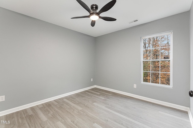 spare room featuring ceiling fan and light hardwood / wood-style flooring