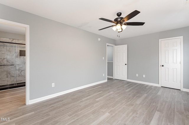 unfurnished bedroom with ensuite bath, ceiling fan, and light hardwood / wood-style flooring