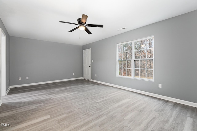 unfurnished room with ceiling fan and light hardwood / wood-style floors