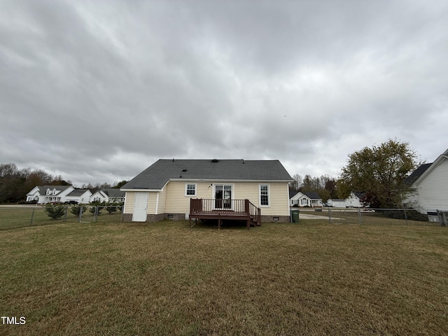 rear view of house with a yard and a deck