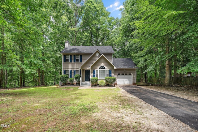 view of front of house featuring a garage and a front yard