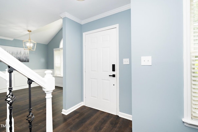 entrance foyer with crown molding, dark wood-type flooring, and an inviting chandelier