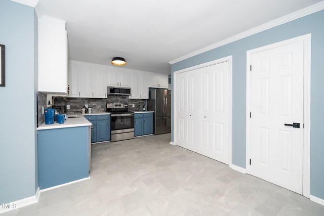 kitchen featuring decorative backsplash, stainless steel appliances, sink, blue cabinetry, and white cabinetry