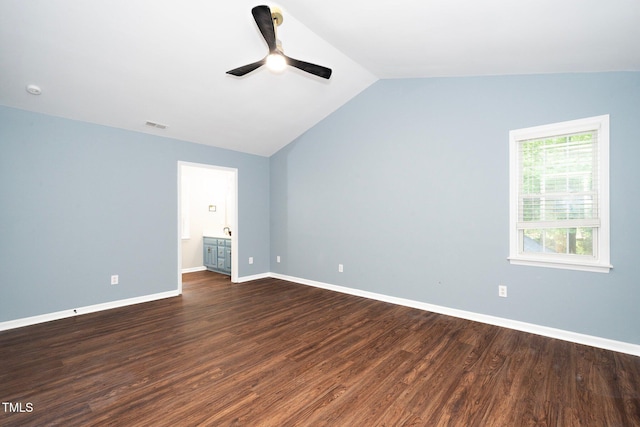 unfurnished bedroom featuring ceiling fan, dark hardwood / wood-style floors, connected bathroom, and vaulted ceiling