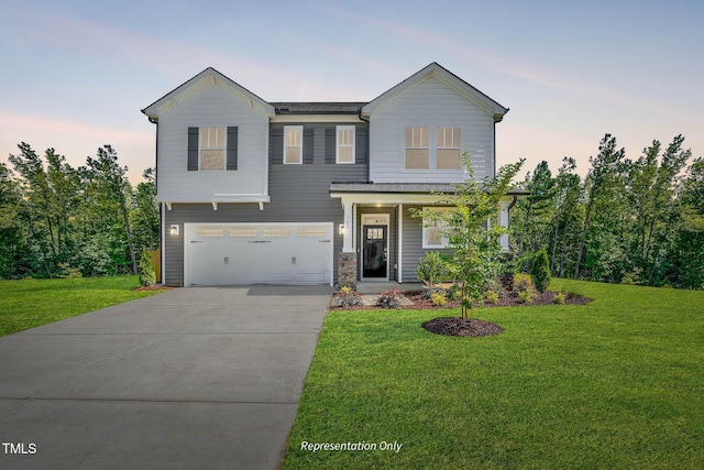 view of front of house featuring a yard and a garage