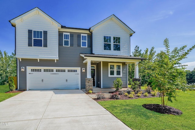 view of front of home featuring covered porch, a front yard, and a garage