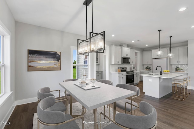 dining area featuring dark hardwood / wood-style flooring and sink