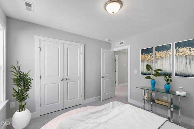 bedroom with a closet and light colored carpet