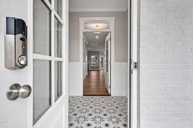 interior space with tile patterned flooring and ornamental molding