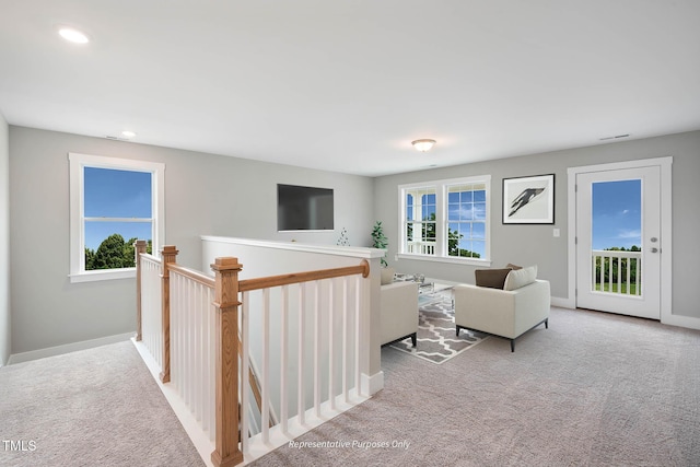 living room featuring light carpet and plenty of natural light